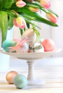 Colored eggs with bows and tulips for Easter